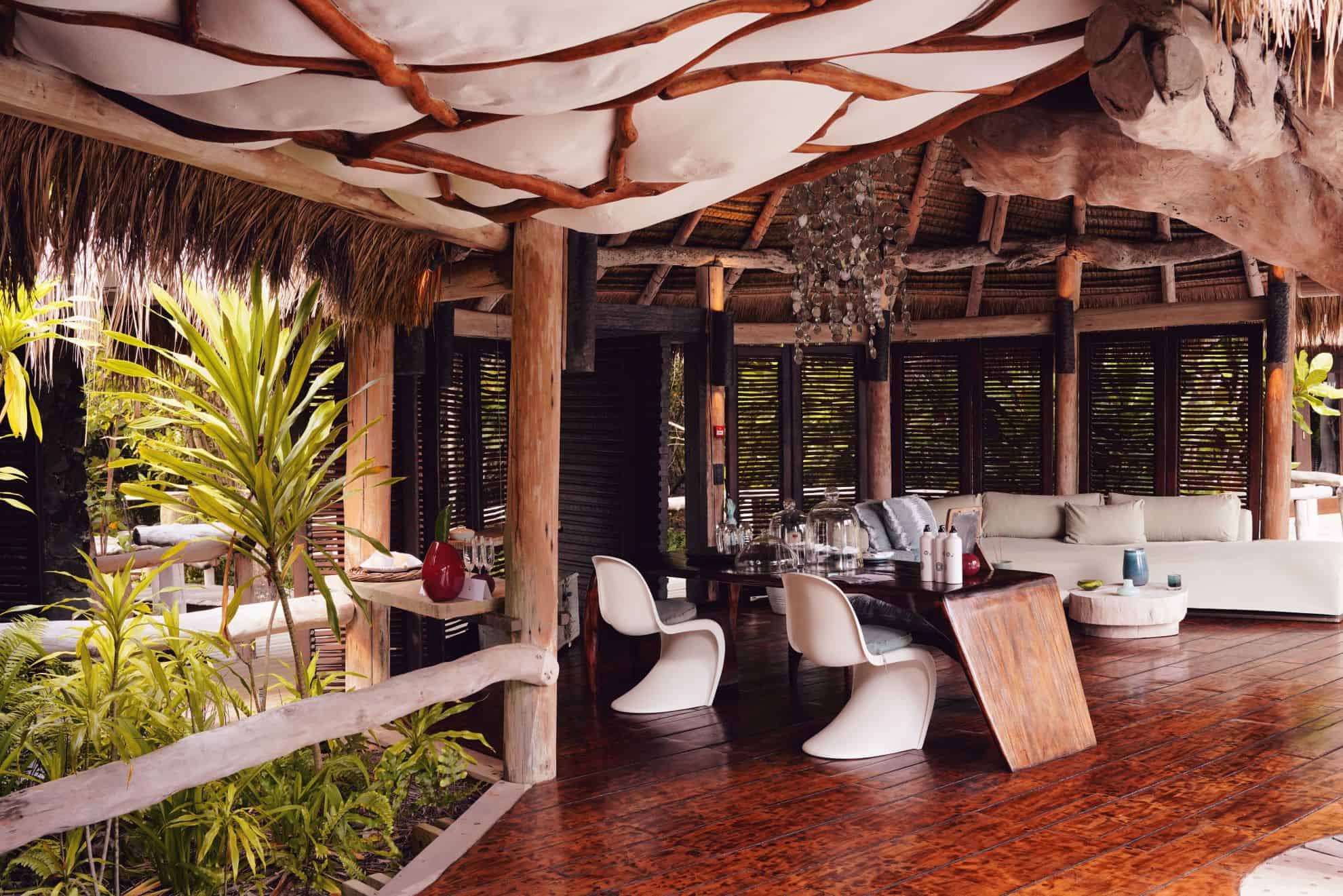 Seating area with couch, table and thatched roof