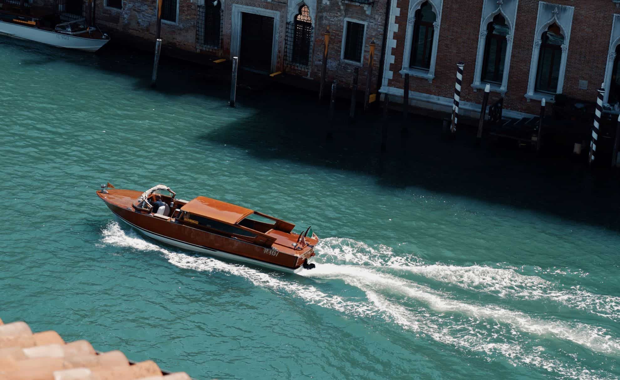 A power boat moving through the waterways of Venice, Italy
