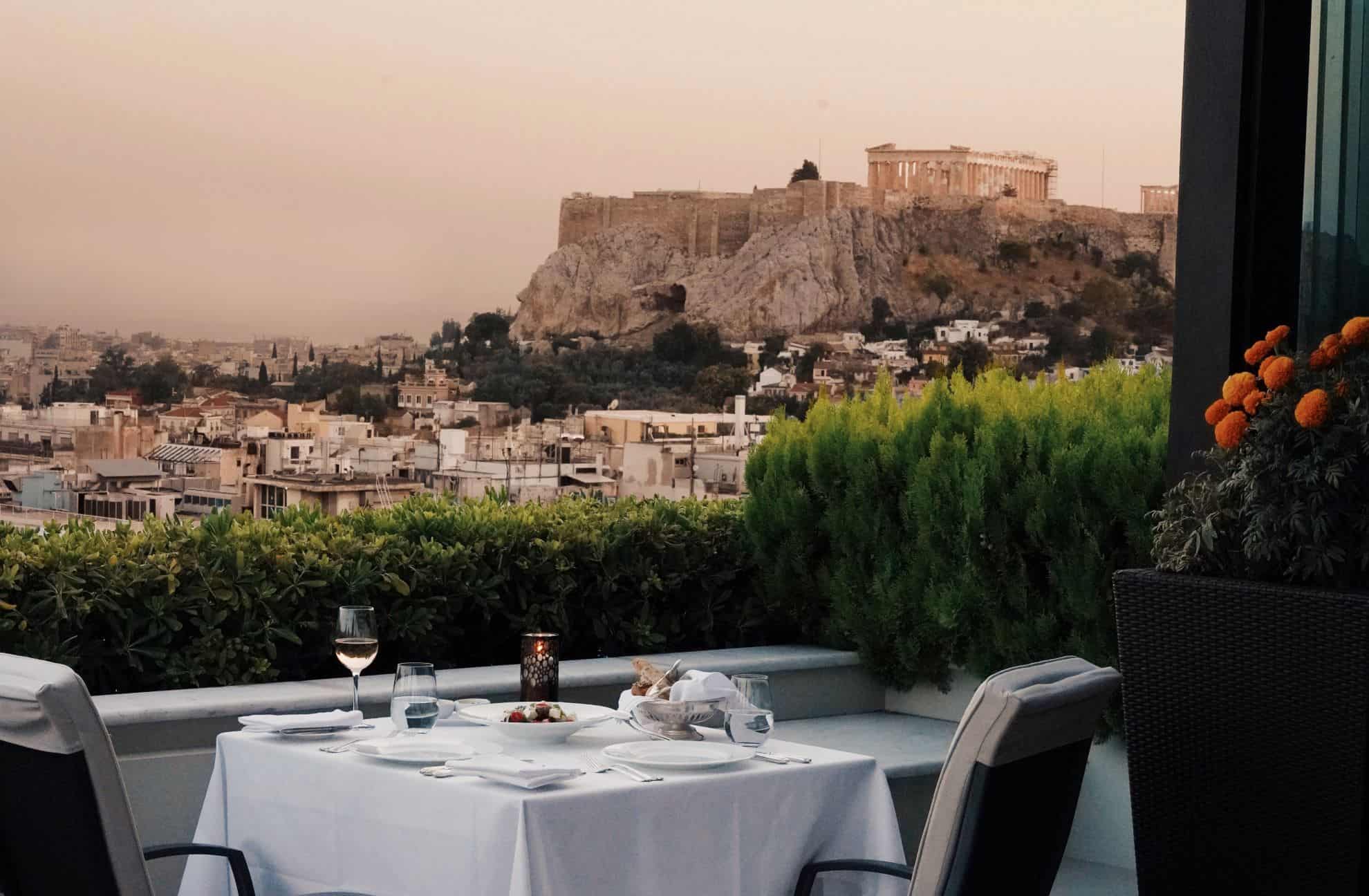 Finely set outdoor table on patio overlooking historic city and sites