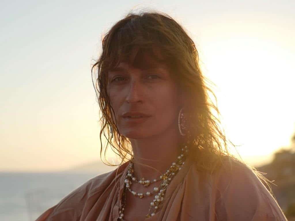 Caroline de Maigret standing in sun with water in background