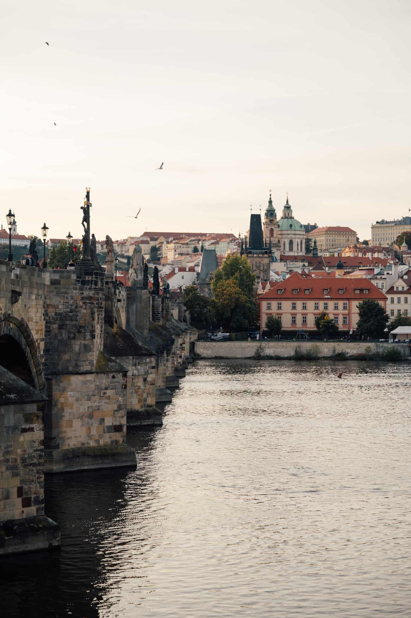 View of European town across a river with a bridge alongside