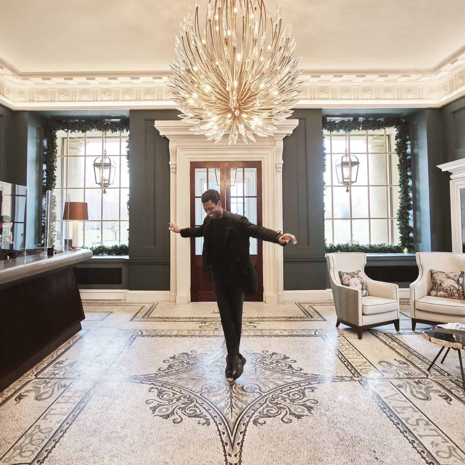 Man holding ballet pose in lobby of The Langley