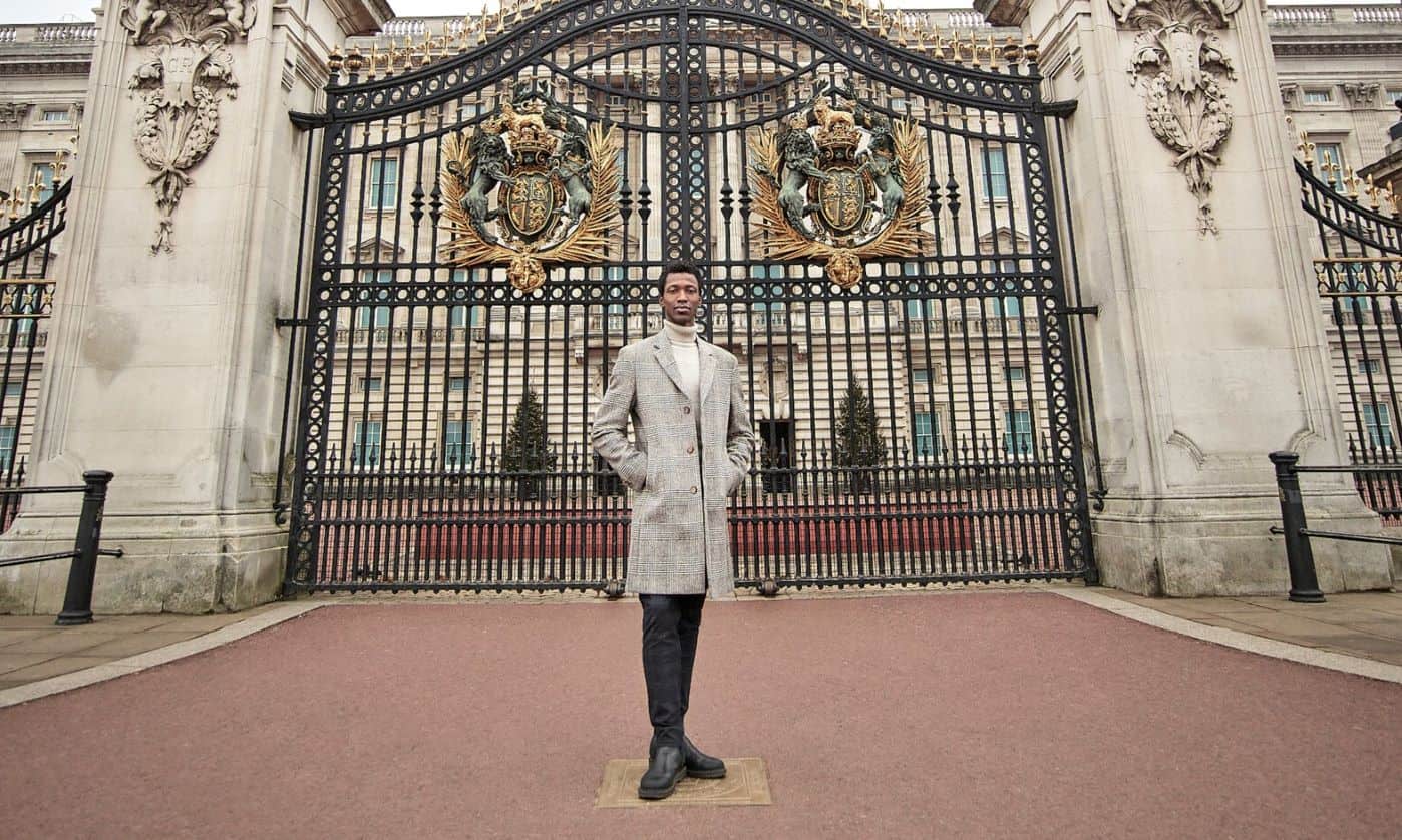 Calvin Royal standing in front of Buckingham Palace