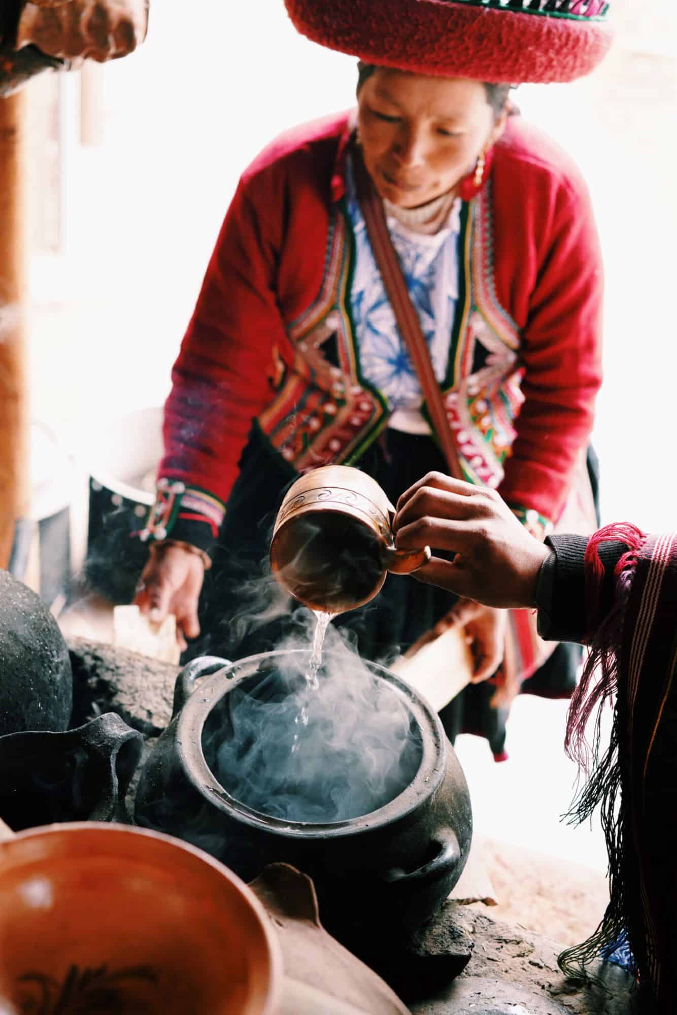 Women tending to cooking with indigenous pots and fire