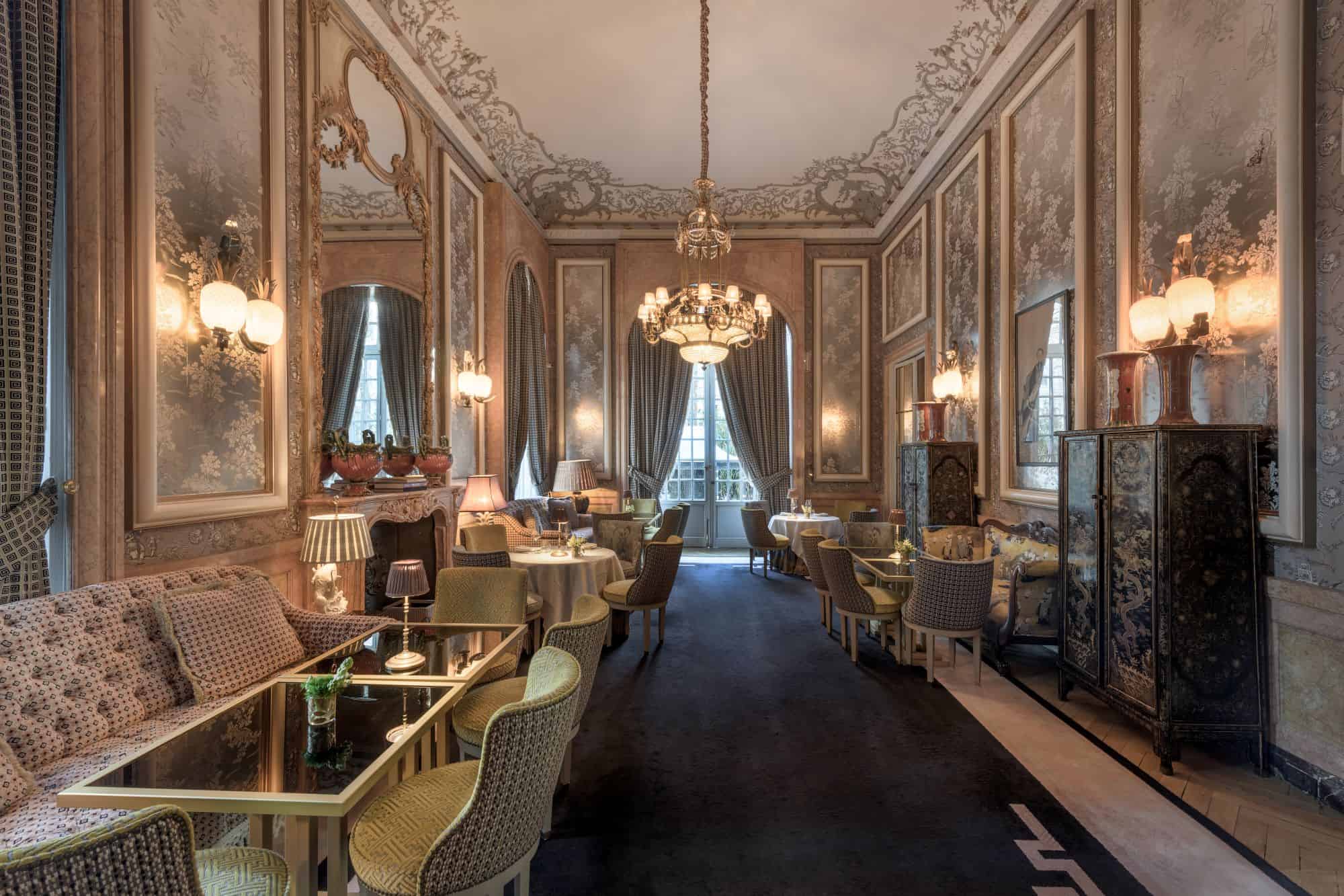 Upscale Victorian-style sitting area with varied seating and decorative art panels on wall