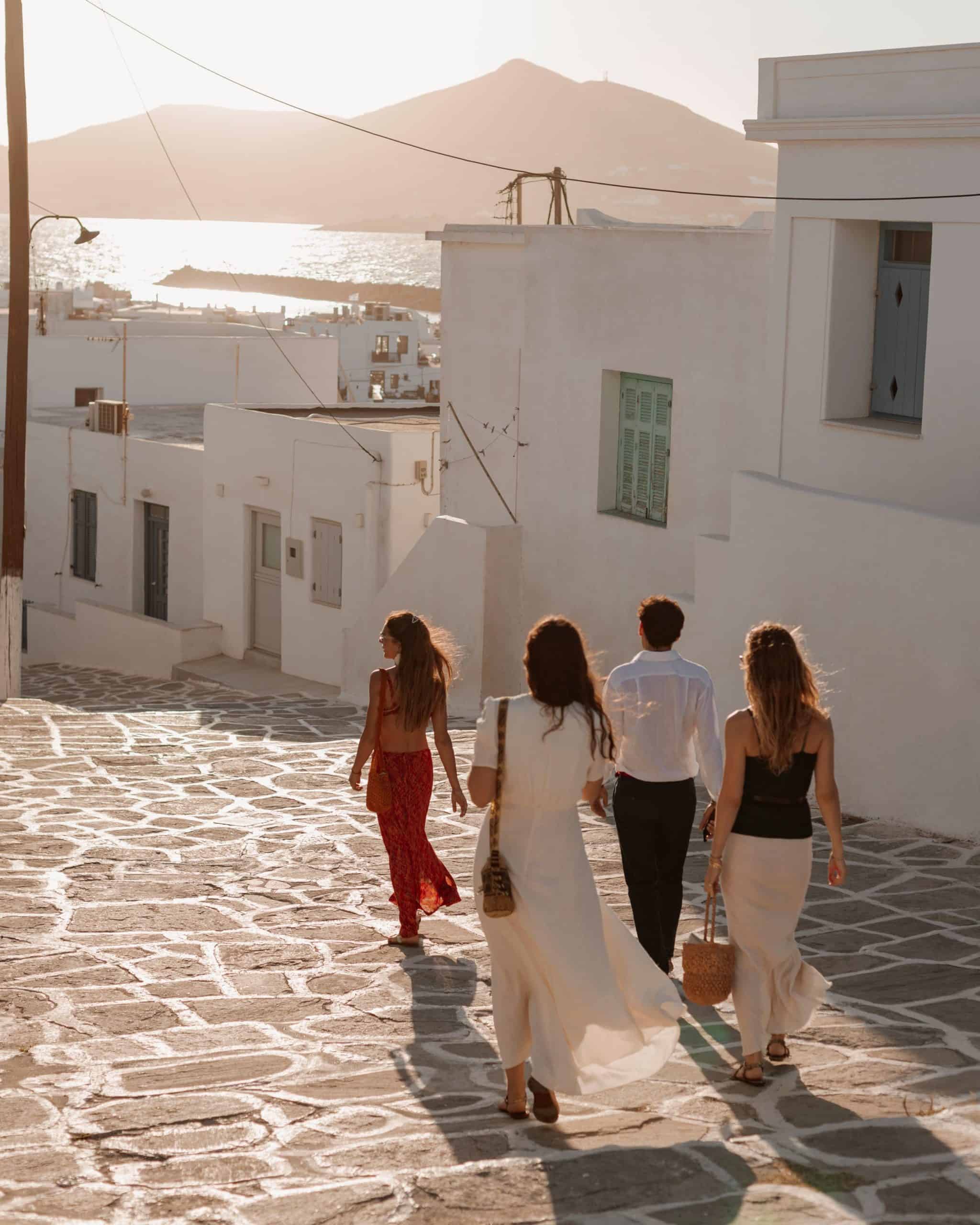Group of people walking on cobblestone street