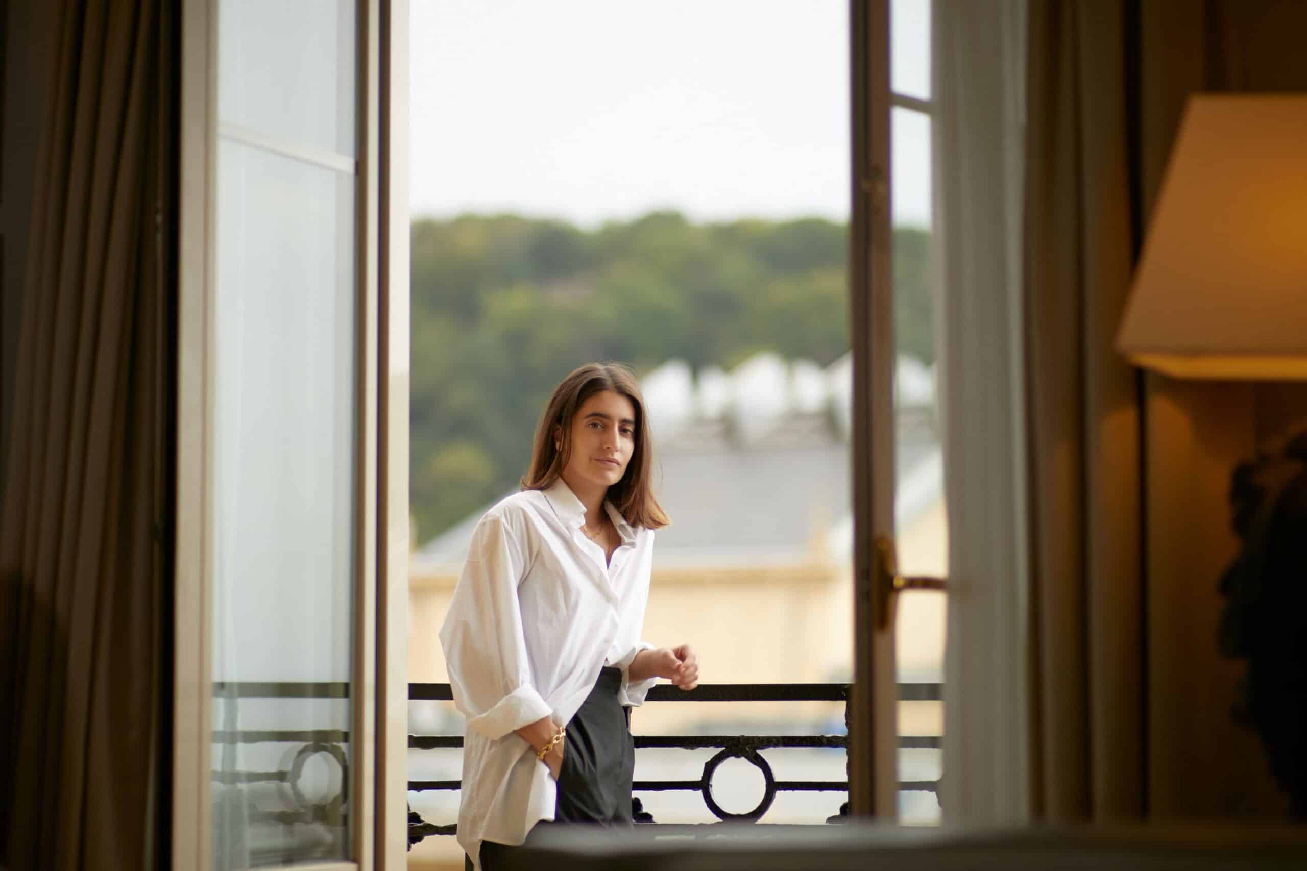 Woman standing on balcony of hotel room