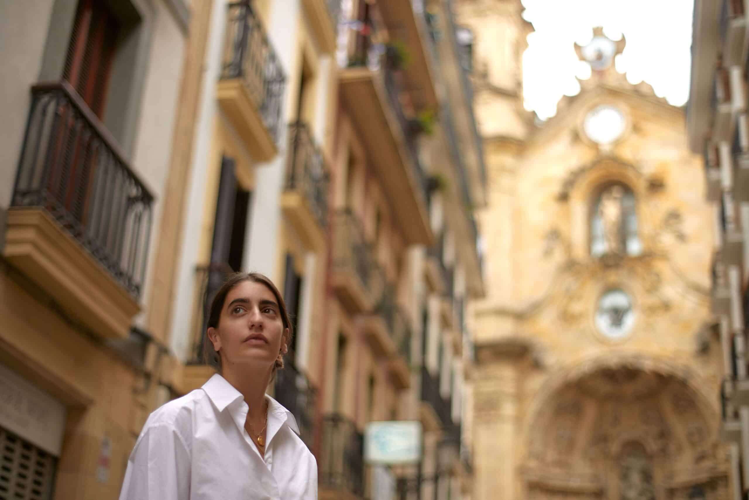 Woman looking into the distance on an old street