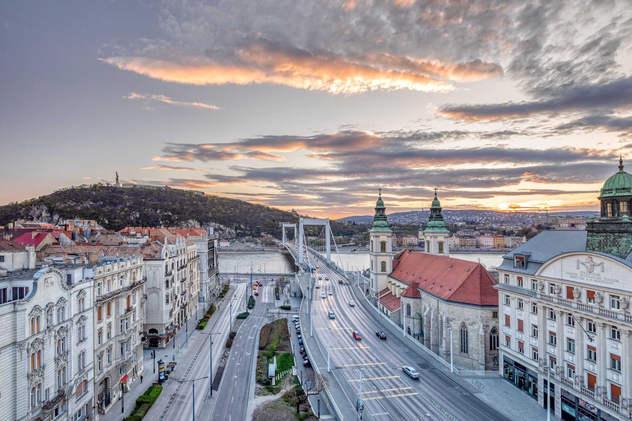 Cars on bridge over a river alongside European street