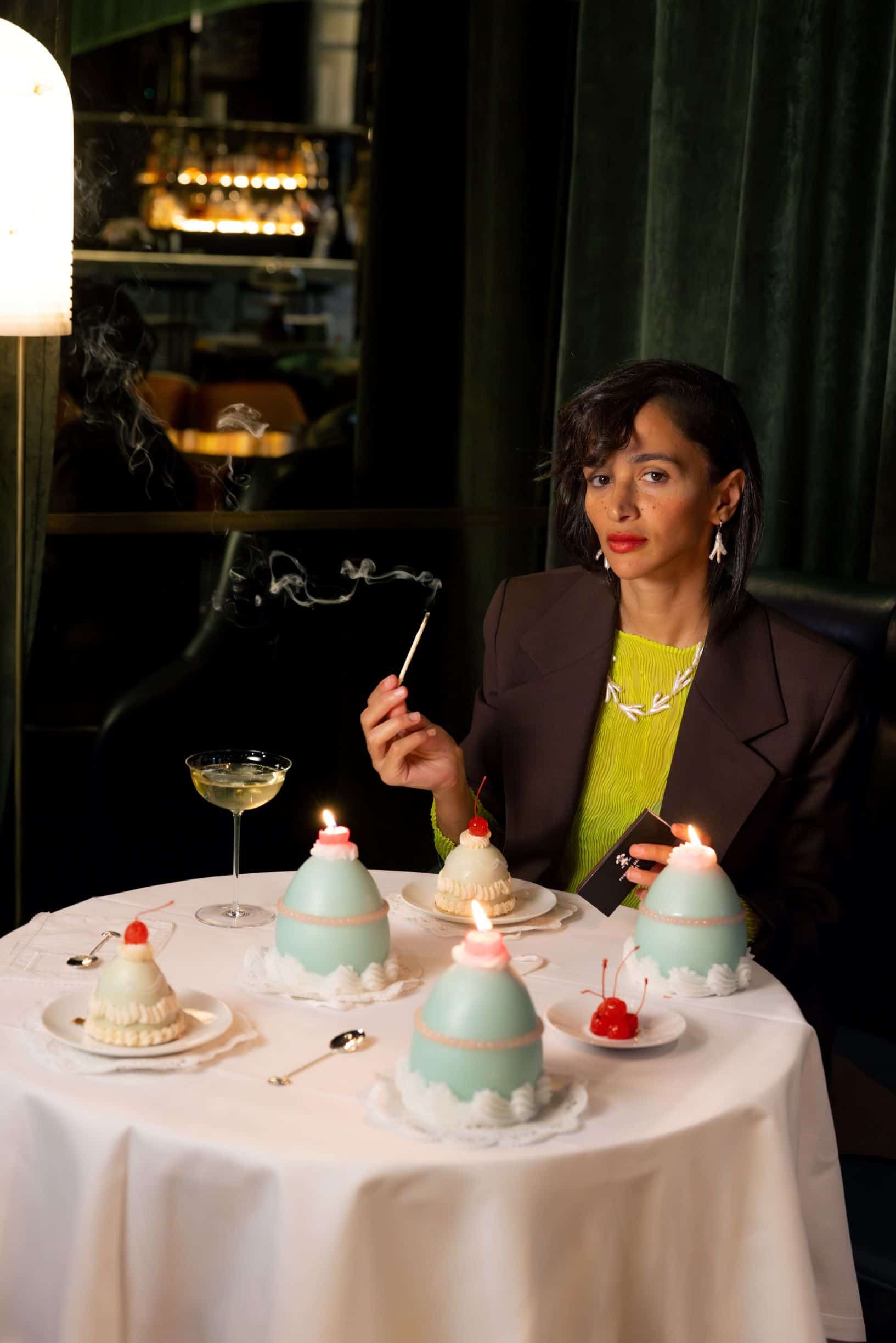 woman lighting a cupcake