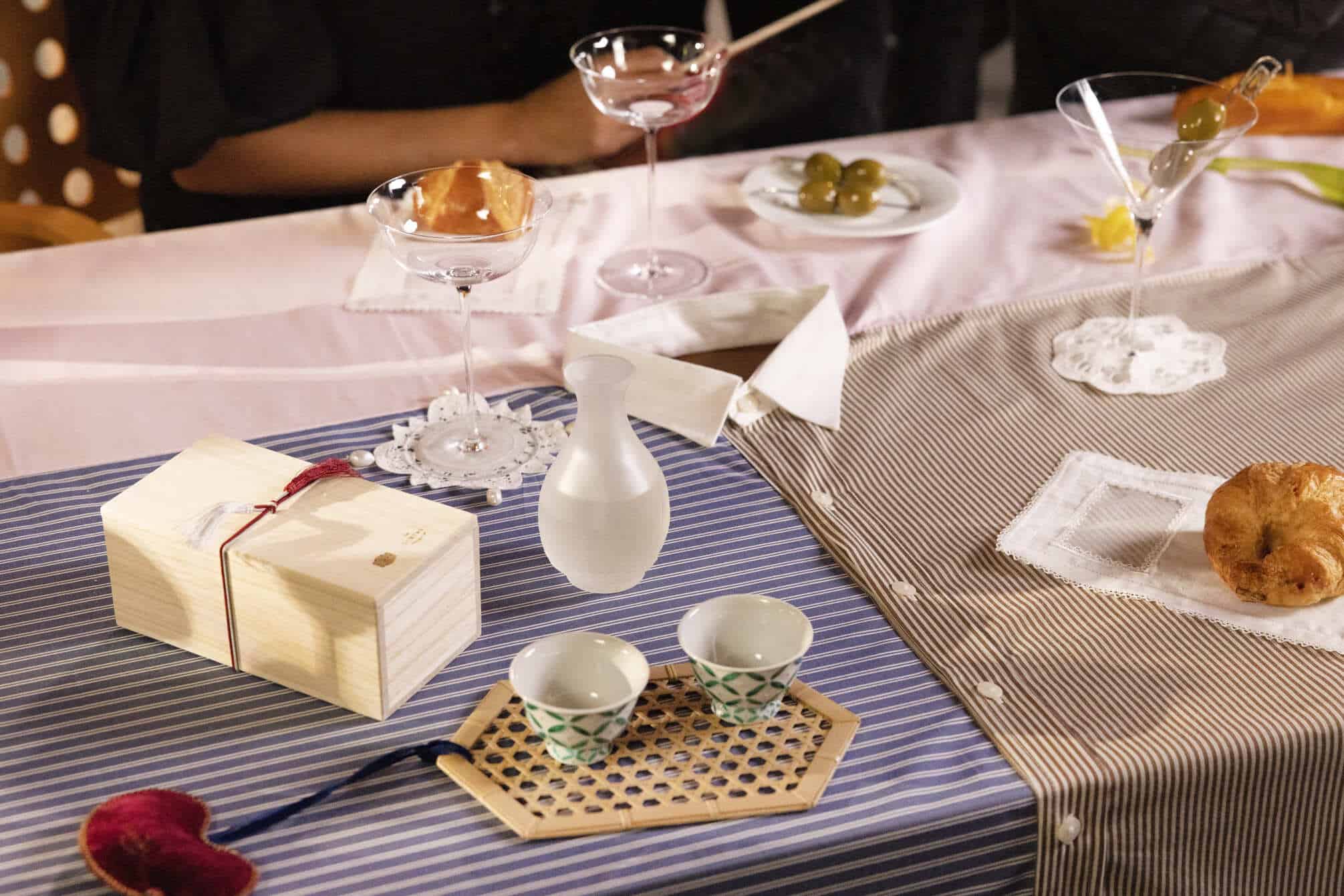 Table set up of tea cups, olives, and croissant