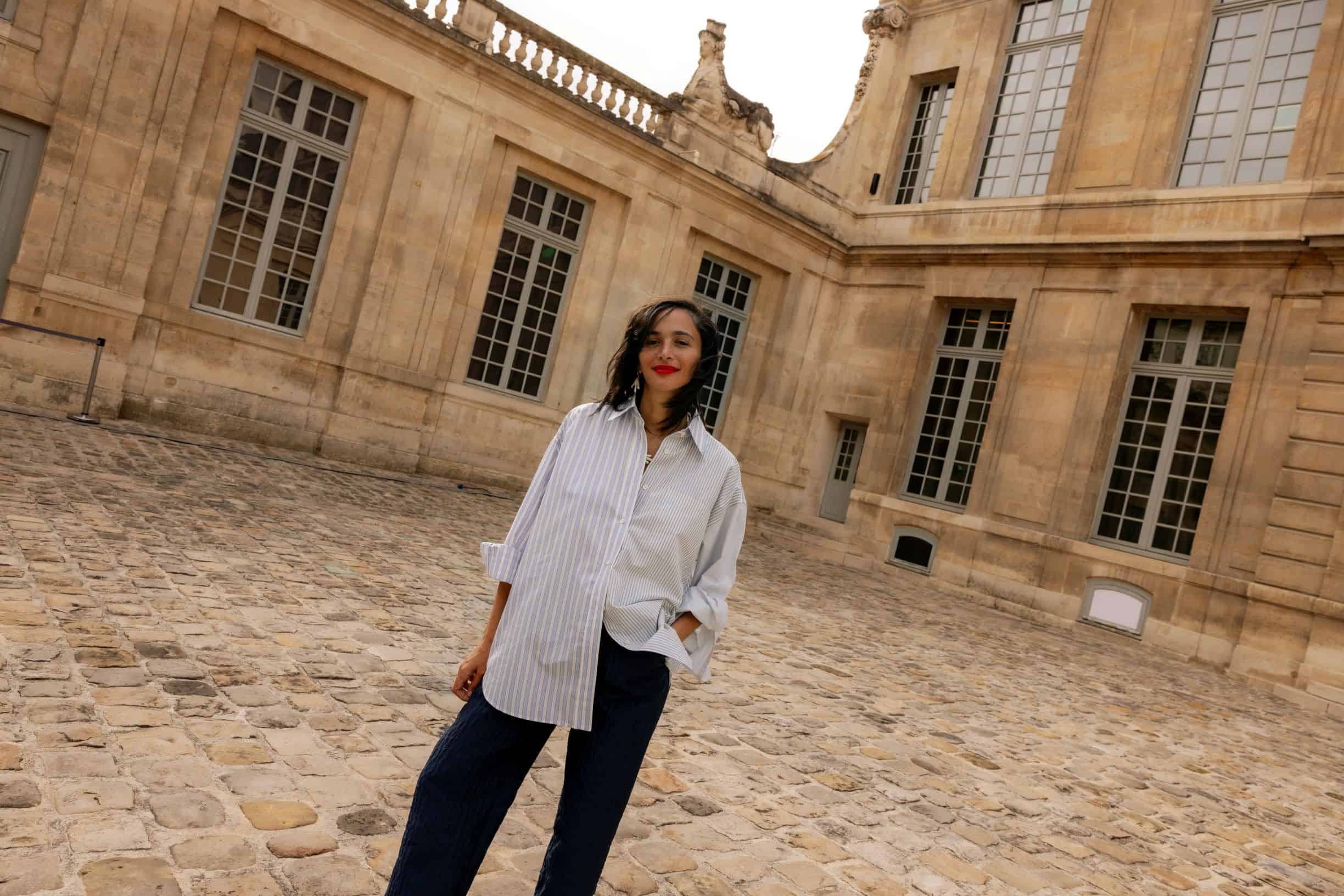 angled photo of woman in front of marbled building